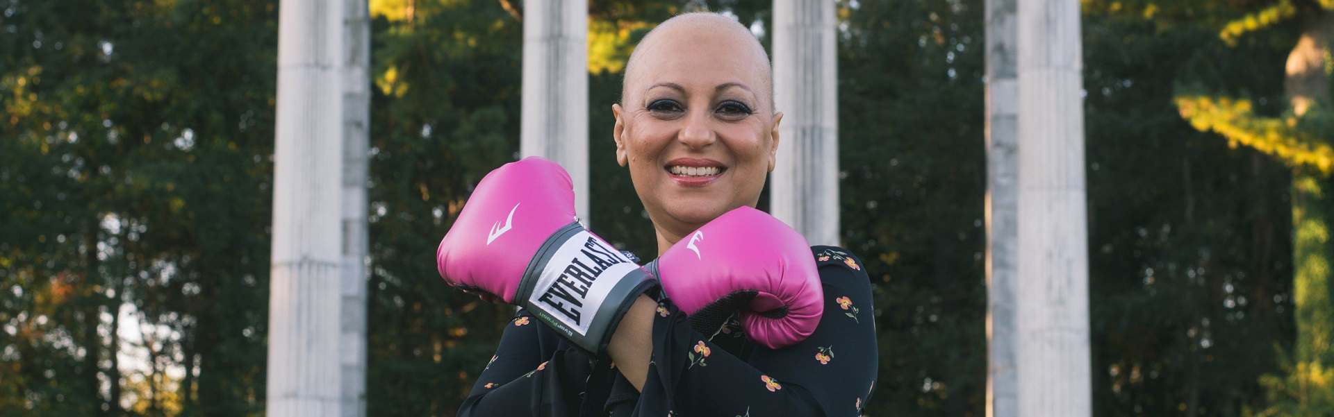 Woman Standing by Government Building with boxing Gloves on